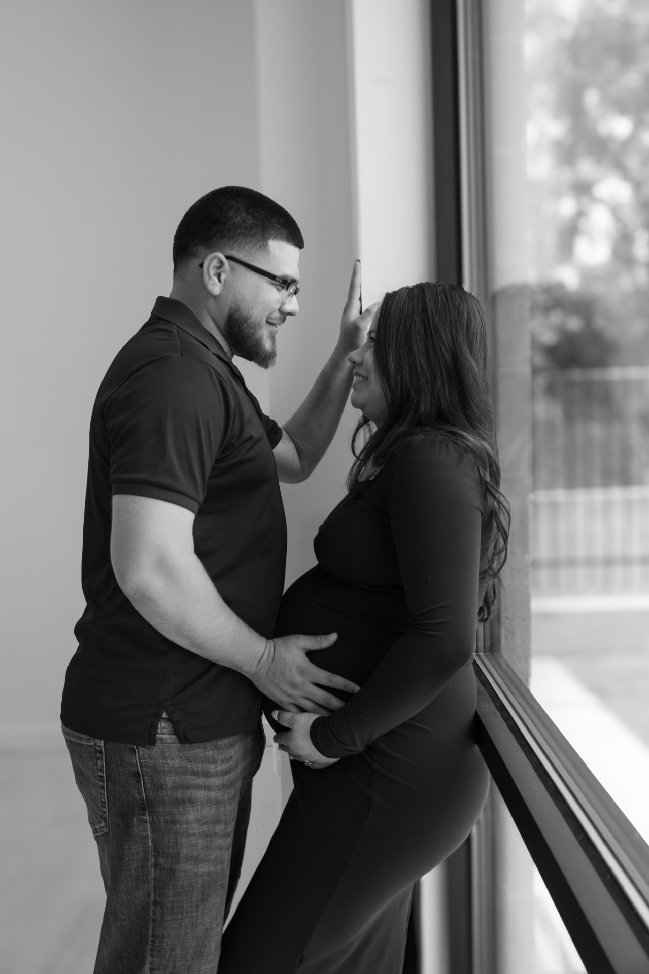 Expectant couple by a bright window